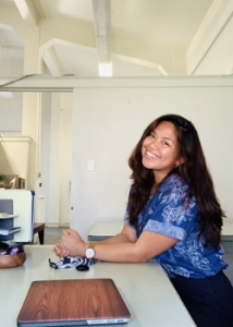 shot of Sarah Look smiling at camera while sitting at desk