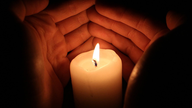 hands around a candle