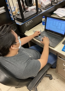 person sitting on a chair working on a computer