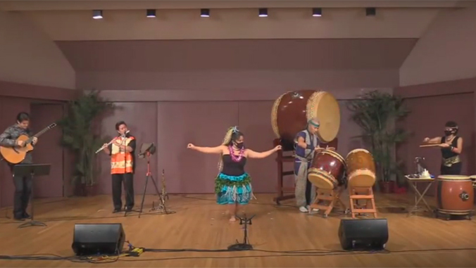 one guitar player, flute player, hula dancer, and two taiko drummers