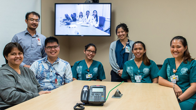 UH Mānoa and UH Hilo students on TV screen smiling