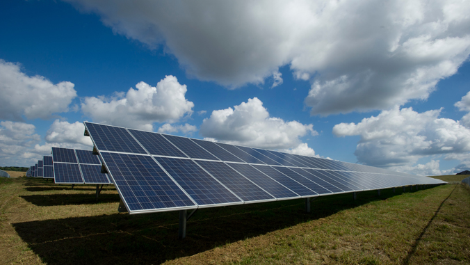 solar panels under clouds and sun