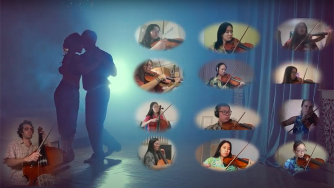 13 string performers on a screen next to two people dancing tango