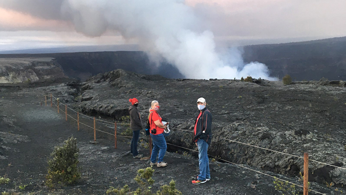 people watching plume from volcano