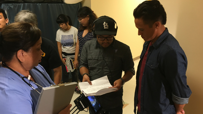 three people looking at scripts