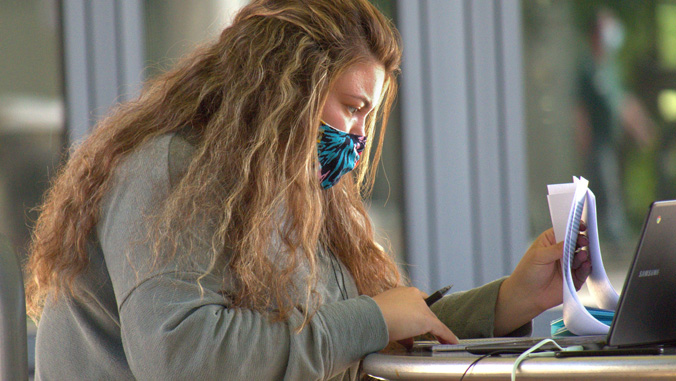 Student studying wearing a mask