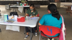 female student at table with patient