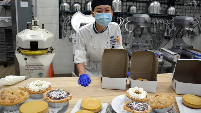 culinary student putting pie in box
