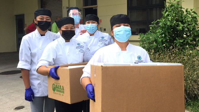 culinary students carrying boxes