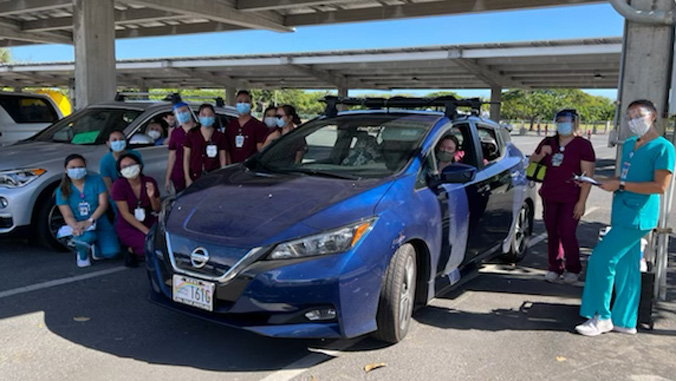 Nursing students with person in a car