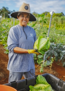 person holding a plant and smiling