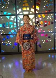 person in a kimono smiling at camera