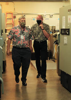 two men walking through building