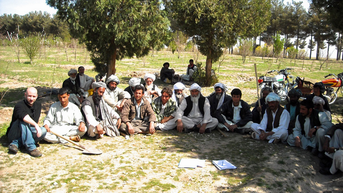 group of people sitting on grass