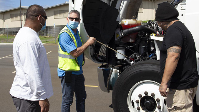 Instructor with students and a truck