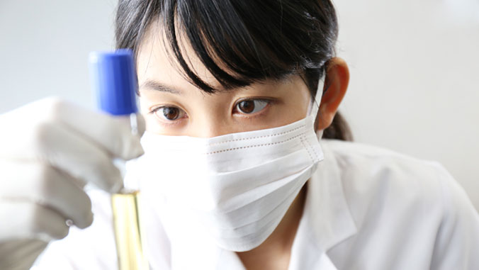 woman looking at science vile