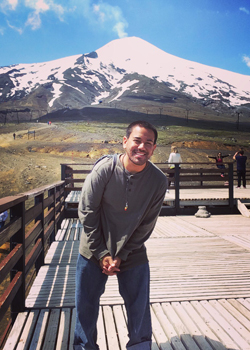 man standing in front of a mountain