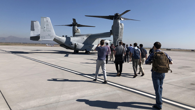 people walking toward an aircraft