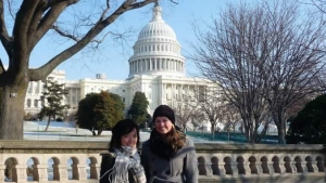 two people smiling at camera standing in front of capitol