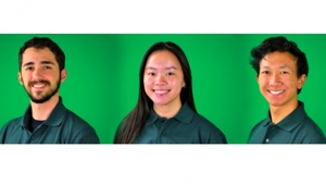 three students smiling at the camera