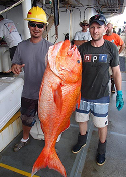 men holding a fish