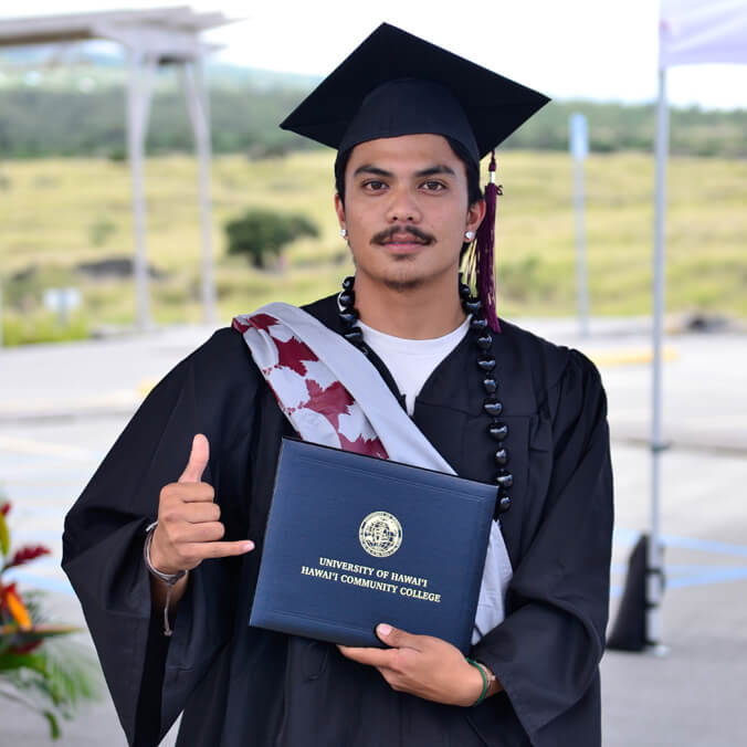 graduate holding diploma