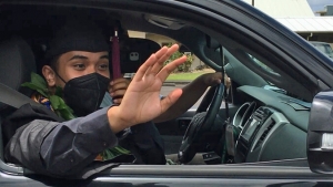 graduate in his car