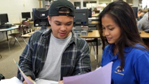 two people looking at a paper