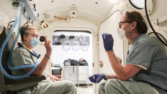 man and woman in the hyperbaric treatment center