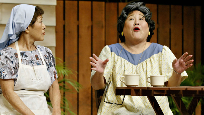 two women performing in a play