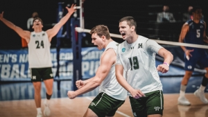 three people celebrate on the volleyball court