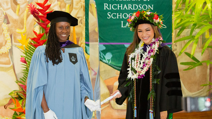 dean handing diploma to law graduate