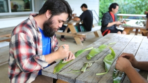 student working on ti leaf