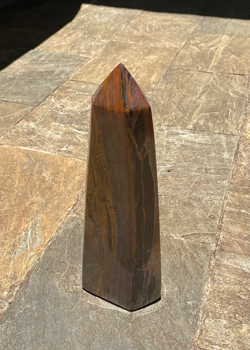 Wooden post in the ground with no shadow