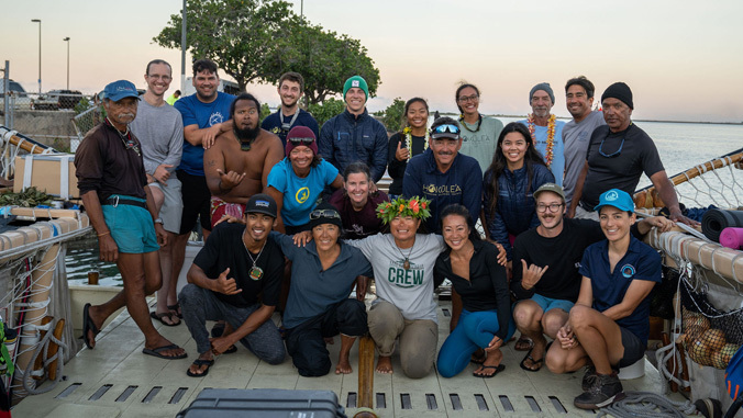 large group on a voyaging canoe