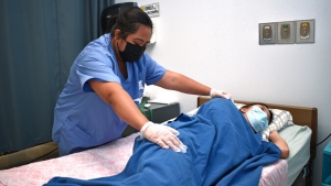 nursing student working with patient