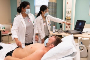 nursing students conducting ultrasound on patient