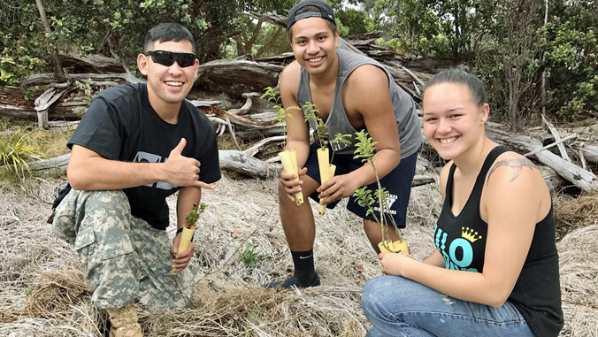 3 people planting