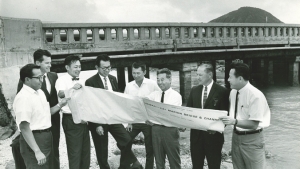 group of people standing in front of bridge