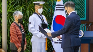 person reading a proclamation to another person