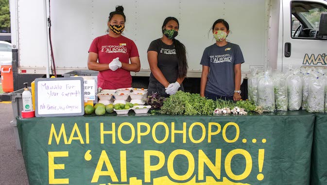 student interns selling produce