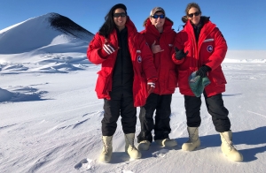 3 people in cold weather clothes in antarctica