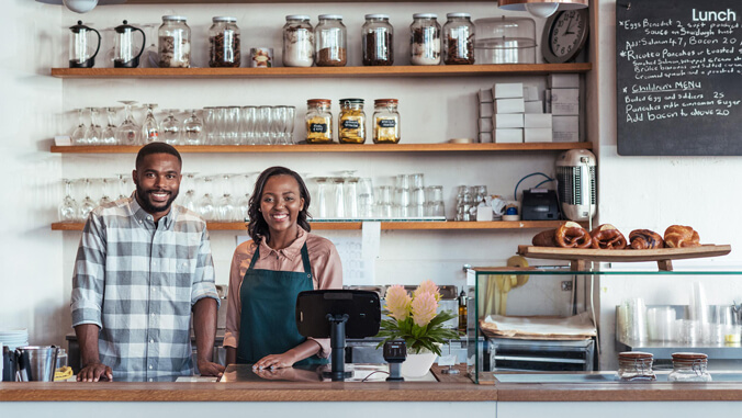 two people behind a cafe counter