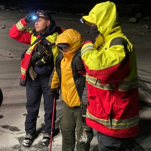 Rescuers with hiker in snow
