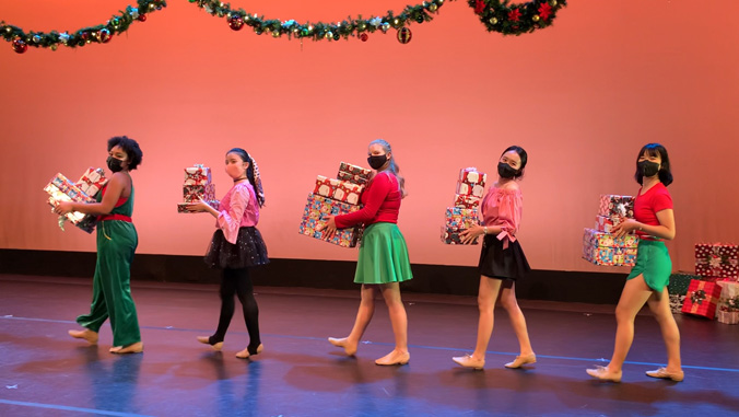 Dancers holding presents