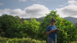 Kahealani Acosta reading outside