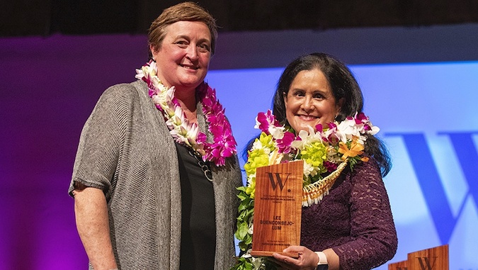 two women wearing lei