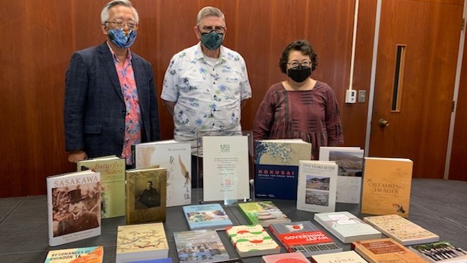 three people with books