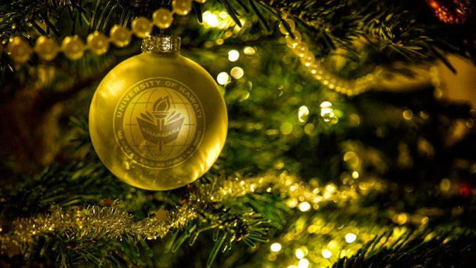 Gold Christmas ornament with the U H seal