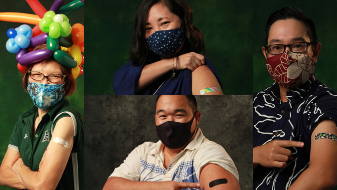 Four people in masks with band-aids on arms